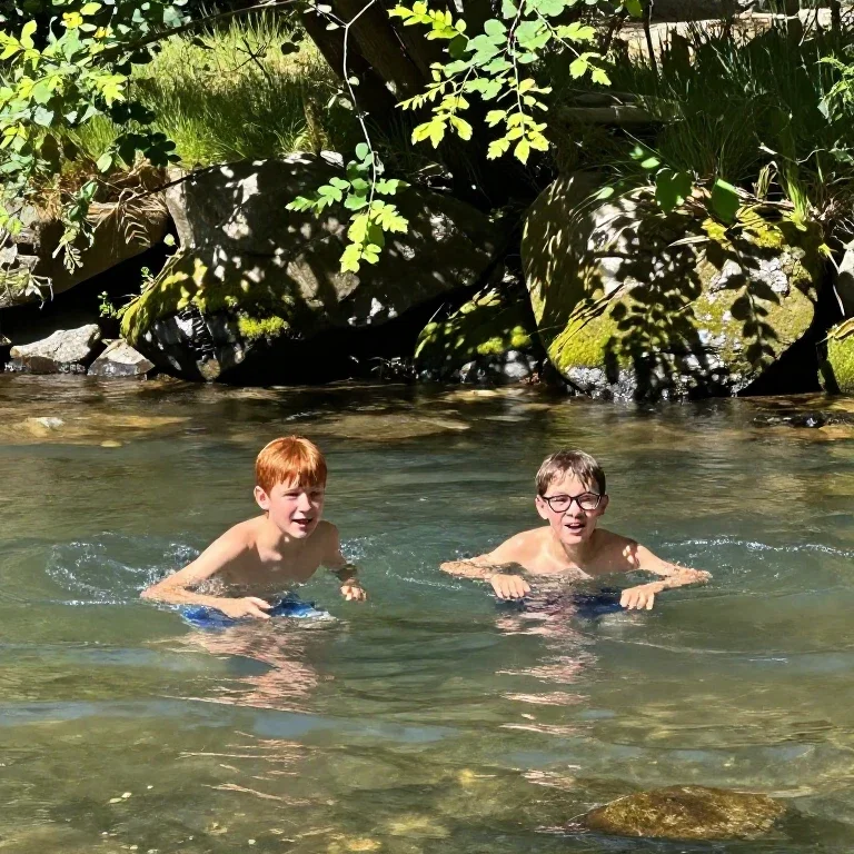 two boys swimming in stream